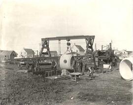 Men laying sewer pipe in trenches