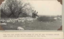 Men at base of main building of the Fort