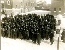 Wintertime group of about 200 men at an event in Moose Jaw