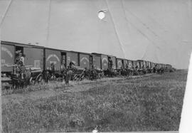 CNR Railway cars, with men unloading railroad ties