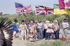 Henry Beaudry in traditional regalia bearing a sacred eagle staff