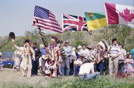 Henry Beaudry in traditional regalia bearing a sacred eagle staff