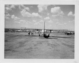 Many airplanes and people on runway