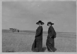 Two women walking in a field