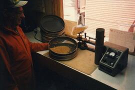 Jim Cole, Pioneer agent, grading wheat