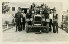 Firemen seated on fire truck