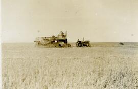 Tractor pulling combine and straight cutting crop