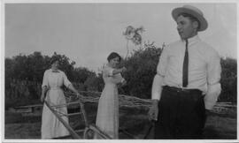 Two women holding a walking plow