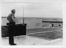 Man standing on roof of old hospital