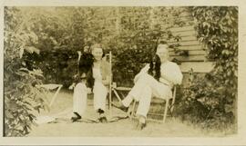 Man and woman holding dogs on their laps