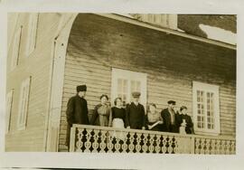 Seven adults gathered on hotel veranda