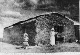 Pioneer sod shack with occupants