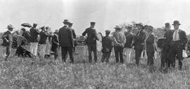 Men with Instruments Gathered in Front of a Train