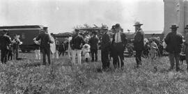 Men with Instruments Gathered in Front of a Train